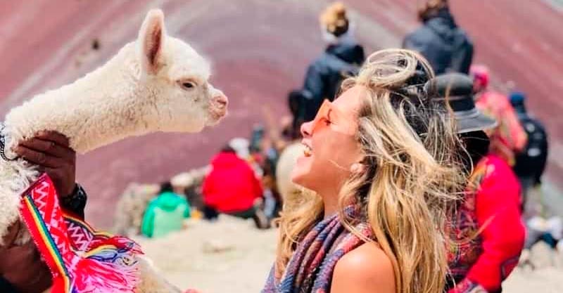 llama and beautiful girl in Rainbow Mountain