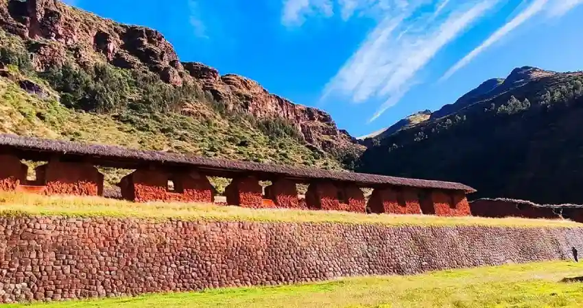 Ruins of Huchuy Qosqo, an Inca citadel in Peru, showcasing ancient stone structures against a mountainous backdrop.