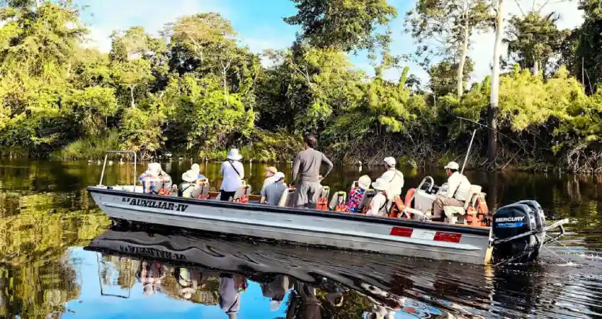 A group of tourists enjoying a boat ride in the water at Pacaya Samiria National Reserve.