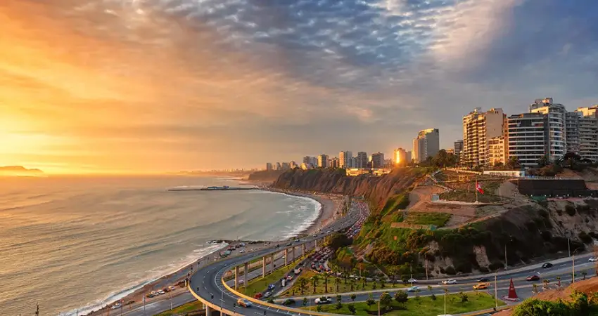Sunset over Lima, Peru, showcasing vibrant colors illuminating the city skyline. Luxury Lima Tours.
