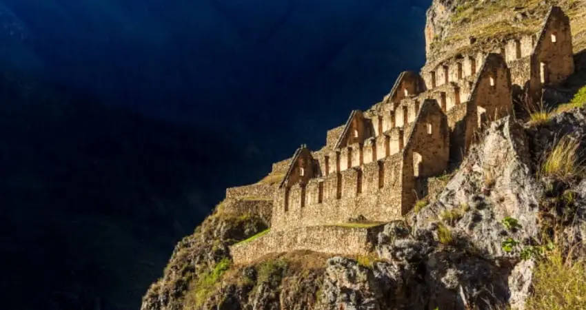 Ruins of Ollantaytambo in Peru, showcasing ancient stone structures amidst lush green mountains during a week-long visit.